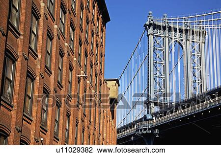 Stock Image - Bridge beside building. Fotosearch