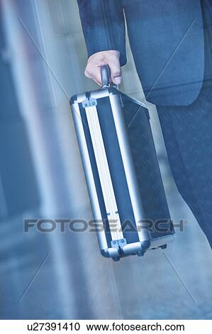 Stock Image - Businessman holding briefcase. Fotosearch