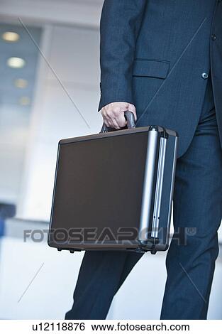Businessman holding briefcase View Large Photo Image Stock Photograph - Businessman holding briefcase. Fotosearch