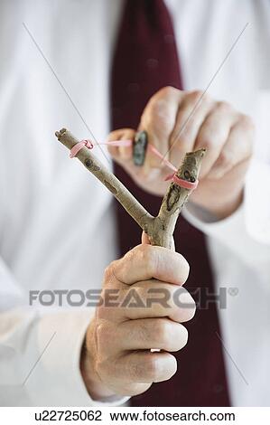 Businessman with sling shot View Large Photo Image Stock Image - Businessman with sling shot. Fotosearch