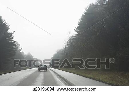 Picture - Car driving on rural road. Fotosearch