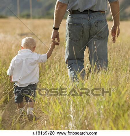 Stock Image - Child holding father's hand. Fotosearch