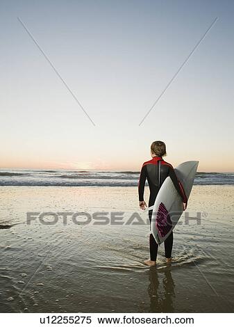 Child holding surfboard View Large Photo Image Stock Photography - Child holding surfboard. Fotosearch