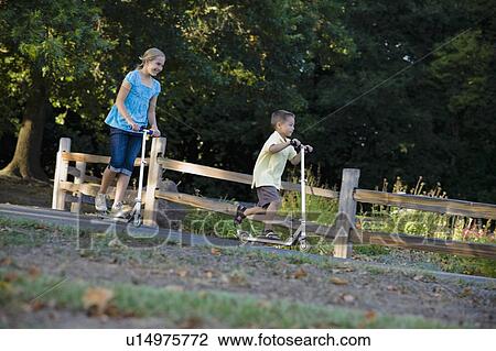 Stock Image - Children riding scooters. Fotosearch