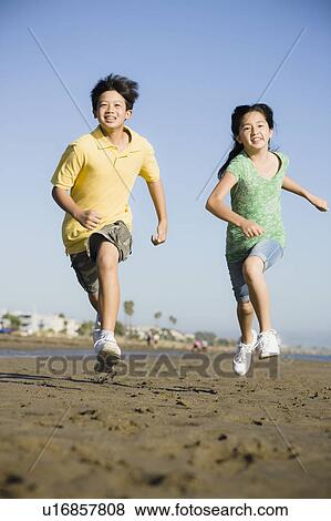 Children running on beach View Large Photo Image Stock Photo - Children running on beach. Fotosearch