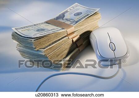 Stock Image - Computer mouse beside money. Fotosearch