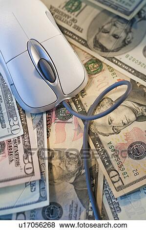 Computer mouse on top of money View Large Photo Image Stock Photo - Computer mouse on top of money. Fotosearch