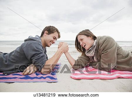 Stock Photo - Couple arm wrestling. Fotosearch