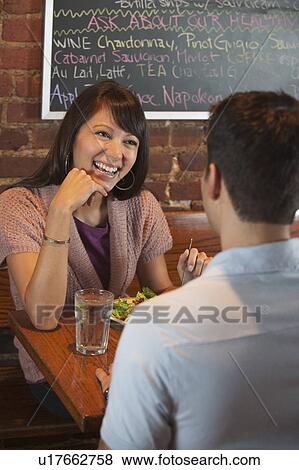 Stock Photo - Couple eating at restaurant. Fotosearch