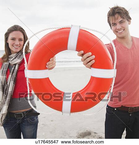 Couple holding life ring View Large Photo Image Stock Photo - Couple holding life ring. Fotosearch