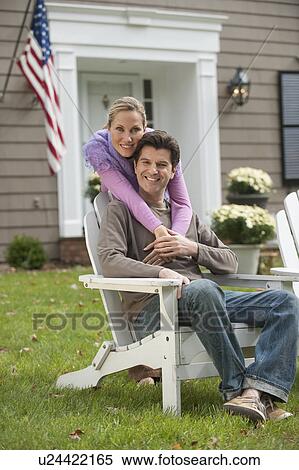 Stock Photography - Couple in front of house. Fotosearch