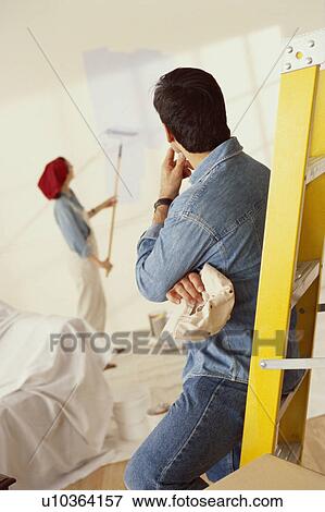Couple painting home View Large Photo Image Stock Photo - Couple painting home. Fotosearch