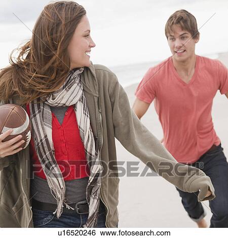 Stock Photograph - Couple playing football. Fotosearch