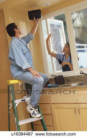 Couple remodeling kitchen View Large Photo Image Stock Photo - Couple remodeling kitchen. Fotosearch