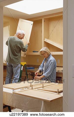 Stock Photo - Couple remodeling kitchen. Fotosearch