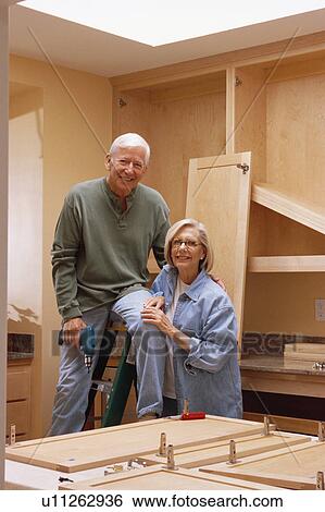 Couple remodeling kitchen View Large Photo Image Stock Photograph - Couple remodeling kitchen. Fotosearch
