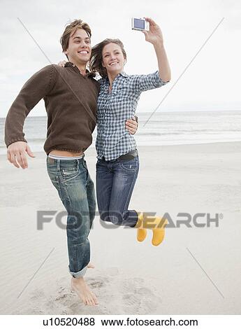 Stock Photo - Couple taking photo. Fotosearch