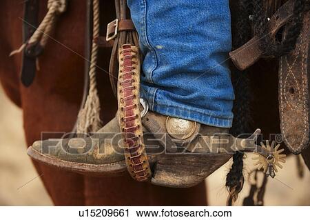 Stock Image - Cowboy boot with spur. Fotosearch