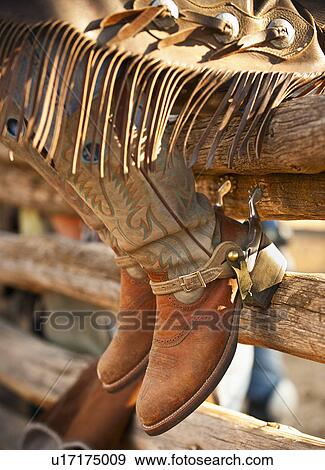 Stock Photo - Cowboy boots on fence. Fotosearch