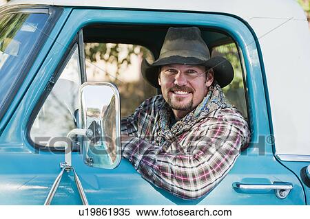 Stock Photography - Cowboy driving truck. Fotosearch
