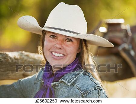 Cowgirl beside fence View Large Photo Image Stock Image - Cowgirl beside fence. Fotosearch