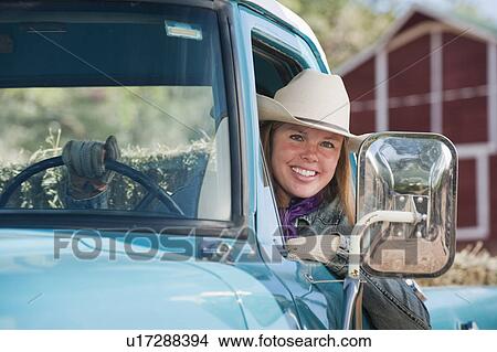 Picture - Cowgirl driving truck. Fotosearch