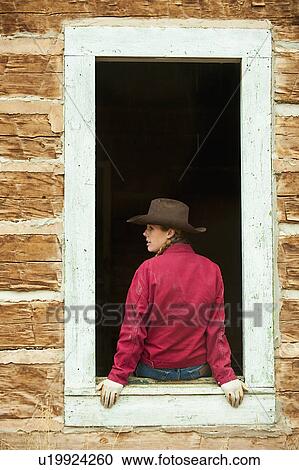 Cowgirl sitting on window ledge View Large Photo Image Stock Image - Cowgirl sitting on window ledge. Fotosearch