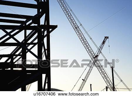 Stock Photograph - Cranes at construction site. Fotosearch