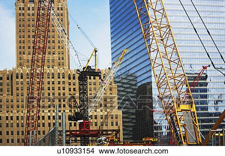 Picture - Cranes in front of buildings. Fotosearch
