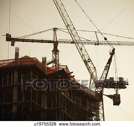 Stock Photo - Cranes working. Fotosearch