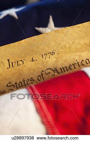 Stock Photo - Declaration of Independence of top of American flag. Fotosearch