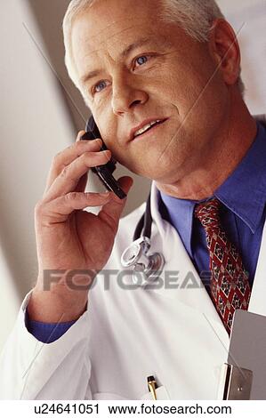 Doctor talking on phone View Large Photo Image Stock Image - Doctor talking on phone. Fotosearch