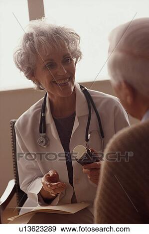 Stock Photo - Doctor talking to patient. Fotosearch
