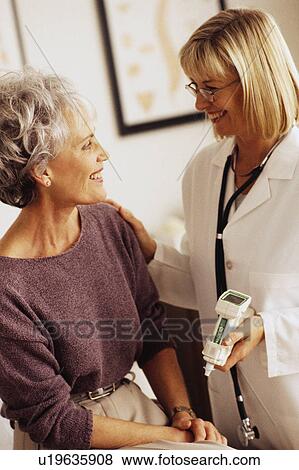 Doctor talking to patient View Large Photo Image Stock Photo - Doctor talking to patient. Fotosearch