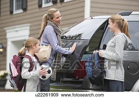 Stock Photo - Family getting in van. Fotosearch