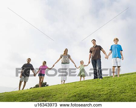 Stock Image - Family holding hands. Fotosearch