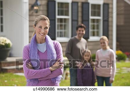Stock Photograph - Family in front of house. Fotosearch