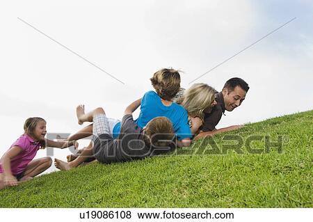 Family playing on grass View Large Photo Image Stock Photo - Family playing on grass. Fotosearch