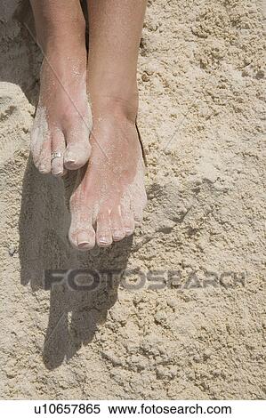 Stock Photography - Feet in the sand. Fotosearch