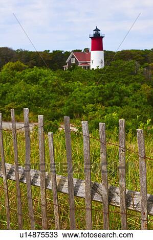 Stock Image - Fence in front of lighthouse. Fotosearch
