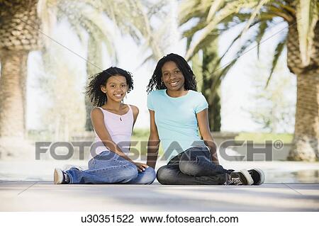 Stock Image - Friends sitting together. Fotosearch