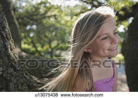 Girl beside tree View Large Photo Image Stock Photo - Girl beside tree. Fotosearch