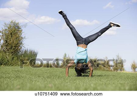 Stock Photo - Girl doing handstand. Fotosearch
