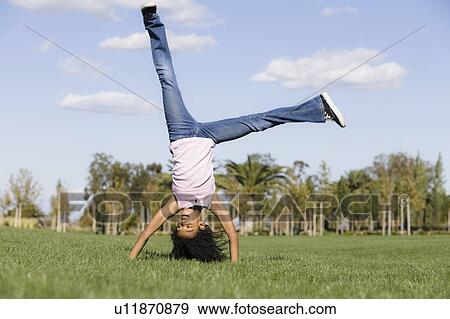 Stock Photo - Girl doing handstand. Fotosearch