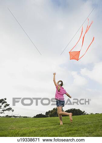 Girl flying a kite View Large Photo Image Stock Image - Girl flying a kite. Fotosearch