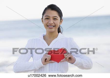 Girl holding heart View Large Photo Image Stock Photograph - Girl holding heart. Fotosearch