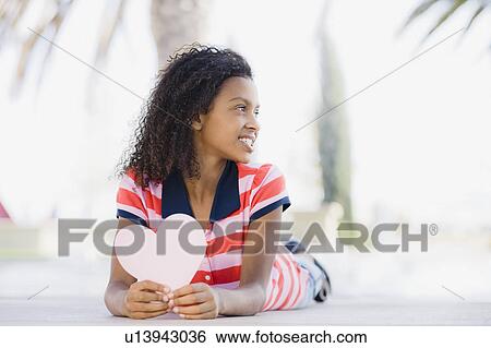 Girl lying down View Large Photo Image Stock Photograph - Girl lying down. Fotosearch
