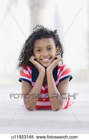 Girl lying down View Large Photo Image Stock Photography - Girl lying down. Fotosearch
