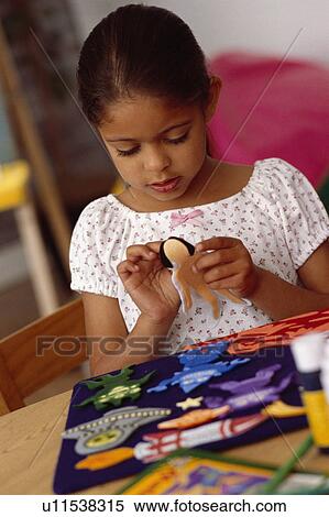 Stock Photography - Girl playing in classroom. Fotosearch