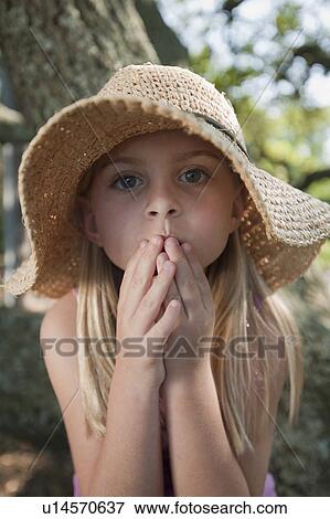 Stock Photo - Girl wearing straw hat. Fotosearch